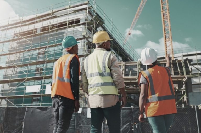 a group of builders assessing progress at a construction site